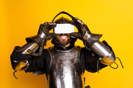 Knight in shiny armor posing against bright yellow background with vibrant energy
