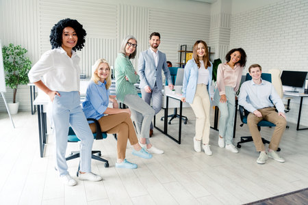 Diverse Team of Business Professionals Standing Together in Modern Office Interiorの写真素材