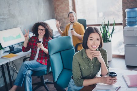 Young professionals collaborating in a modern office with a friendly and diverse environmentの写真素材