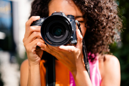 Photo of positive young girl photographer take photos you wear colorful outfit walk park sunlight spring weather travel weekend outsideの写真素材