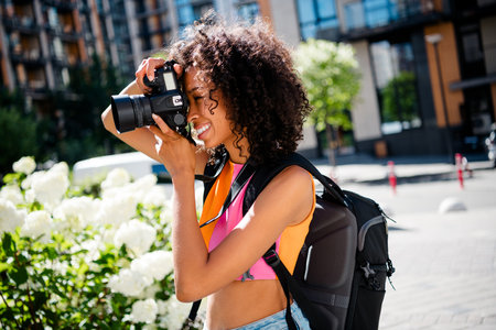 Photo of positive young girl equipment hold camera photographer wear colorful outfit park sunlight...