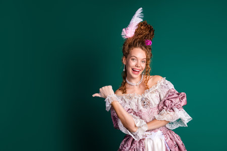 Cheerful woman in elegant baroque costume contrasting historical past with modern life on green...