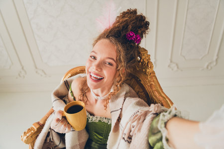 Elegant woman in royal attire enjoying a modern moment