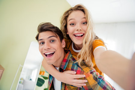 Joyful young couple enjoying a relaxing day at home in a cozy apartmentの写真素材
