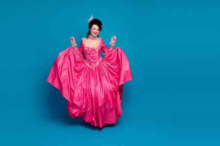 Full length photo of gorgeous excited lady dressed pompous rococo costume dancing empty space...