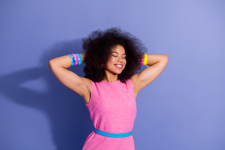 Cheerful woman enjoying leisure in vibrant pink outfit against a colorful backdrop showcasing...