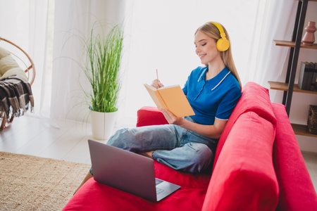 Photo of cute pretty girl wear stylish clothes sit sofa education from home holidays weekend indoors flatの写真素材