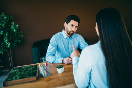 Office colleagues discussing teamwork and collaboration, highlighting synergy in a modern workplace settingの写真素材