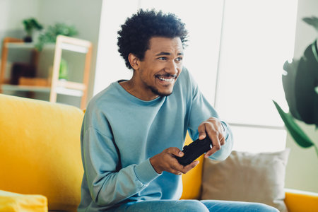 Young man enjoying leisure time at home playing video games on a casual weekend