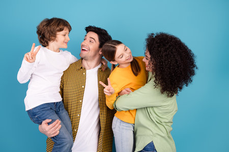 Happy family enjoying togetherness on a casual day with cheerful gestures and bright smiles in a fun and loving atmosphereの写真素材