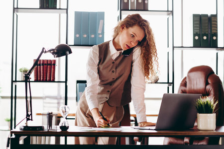 Confident Businesswoman Working Diligently in a Modern Office Setting on Career Advancementsの写真素材