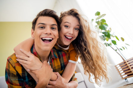 Photo of nice young couple embrace piggyback enjoy modern bright spring cozy interior flat indoorsの写真素材