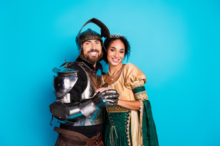 Portrait of a Couple in Medieval Costumes Depicting a Knight and Lady Against a Vibrant Backgroundの写真素材