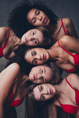 No retouch photo of stunning different fashion models posing together beauty promo on gray concrete wall background in studioの写真素材