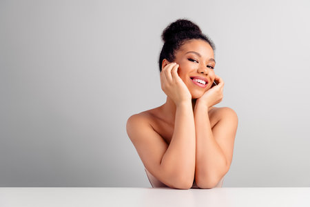 Portrait of a Young Smiling Woman with Elegant Hairstyle and Gentle Natural Beauty in Relaxing Atmosphereの写真素材