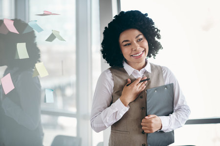 Confident professional businesswoman in office environment with successful attire showcasing job...