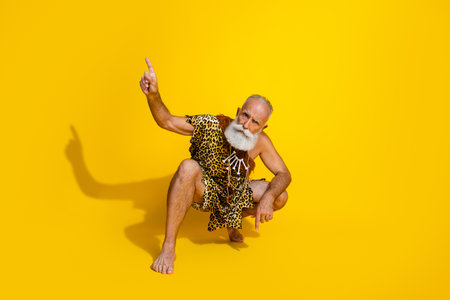 Full body portrait primeval caveman direct finger empty space wear leopard skin clothes isolated on...