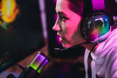 Young female gamer streaming video games with vibrant neon lighting in a cyber environment