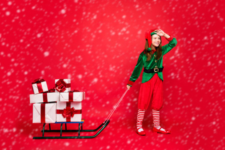 Full length body size view of nice attractive cheerful cheery dreamy pre-teen elf Santa Claus look...