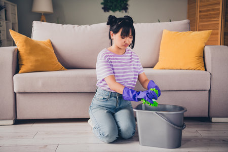 Photo of pretty stressed lady wear casual t-shirt not want wash floor indoors room home houseの写真素材