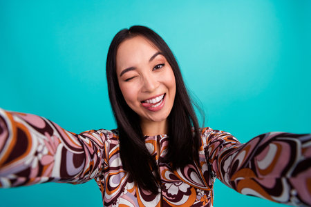 Photo of attractive young woman take selfie photo wink stick tongue out dressed stylish colorful...