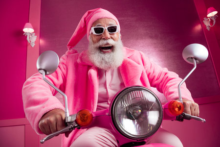 Portrait of overjoyed aged man wear fleece pink coat santa hat drive fast moped hallway backgroundの写真素材