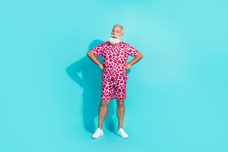 Full body portrait of funky aged man empty space wear leopard print costume isolated on turquoise color backgroundの写真素材