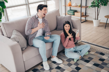 Young couple enjoying quality time together at home in a modern and cozy living space, having fun...
