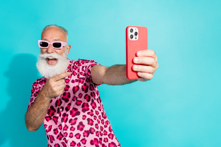 Photo of senior bearded man take selfie photo point device dressed stylish pink leopard print...
