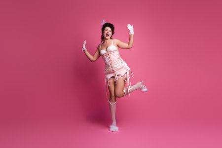 Celebrating femininity in an elegant pink corset with a dynamic pose that captures both past and present stylesの写真素材