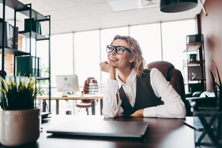 Confident businesswoman in a modern office environment with a stylish appearance and positive...