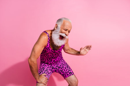 Photo of hilarious positive man wear trendy overall laugh empty space isolated on pink color backgroundの写真素材