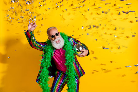 Photo of excited old man showman dance discoball confetti wear glamour striped bright clothes boa...