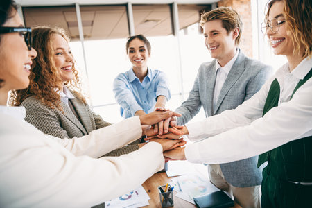Dedicated business team collaborating enthusiastically at the office, showcasing teamwork,...