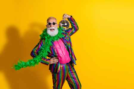 Photo of excited old man showman dance hold discoball wear glamour striped bright clothes boa...