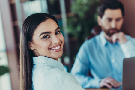 Professionals collaborating in a modern office, focusing on teamwork, diversity, and business developmentの写真素材