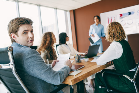 Business professionals collaborating in modern office setting focusing on teamwork and innovative solutions during meetingの写真素材