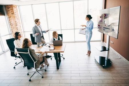 Team presentation in a modern office setting showcasing collaboration, business strategy, and professional teamworkの写真素材