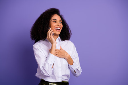 Professional Young Woman on Phone Call in Trendy Fashion Against Purple Background