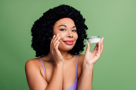 Charming Woman Showcasing Natural Skin Care and Beauty in a Green Background Environmentの写真素材