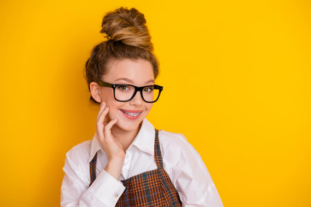 Bright portrait of young teen student with braces and glasses showcasing cheerful charm against a...