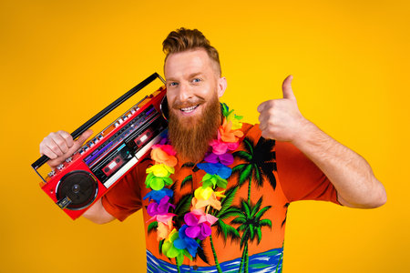 Cheerful Bearded Man Holding a Retro Boombox and Giving a Thumbs Up on Vibrant Yellow Background