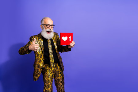 Elderly gentleman celebrates style holding a social notification icon in a vibrant outfit against a...