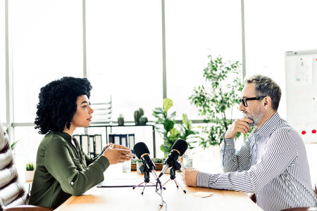 Professional discussion between diverse colleagues in a modern multiethnic office setting during...