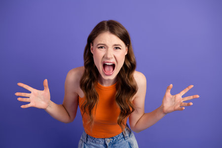 Beautiful young woman showing frustration and emotion on a colorful backdropの写真素材