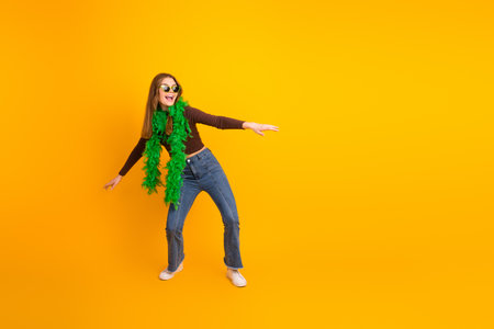 Young woman in colorful outfit posing joyfully against vibrant yellow background, conveying...