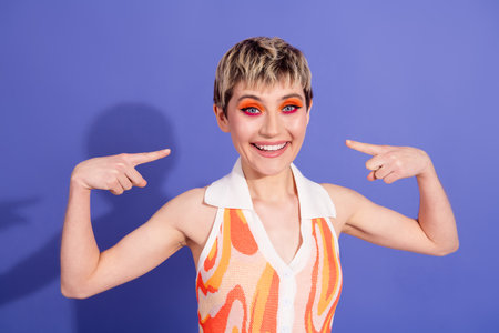 Vibrant girl showcasing bold makeup and retro styled attire on a violet background, radiating...