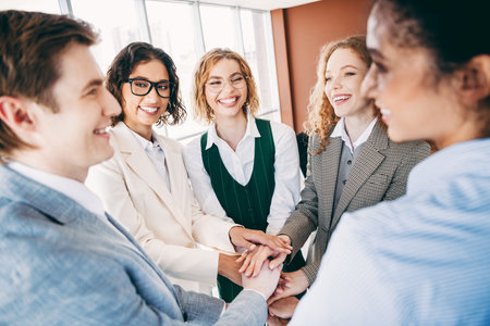 Group of professionals in a modern office engaging in teamwork and collaboration, showcasing diversity and corporate harmonyの写真素材