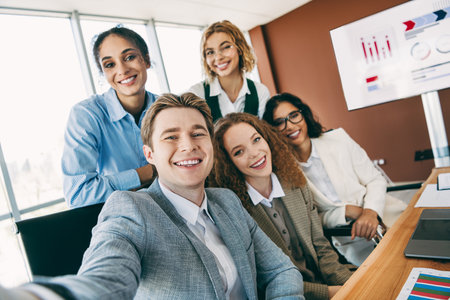 Group of young professionals meeting in office setting for collaborative business discussion and teamwork activitiesの写真素材