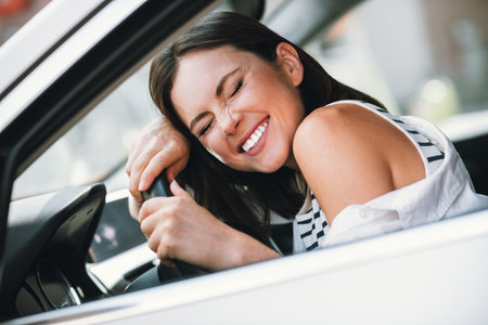 Joyful young woman in casual outfit enjoying a sunny day outdoorsの写真素材